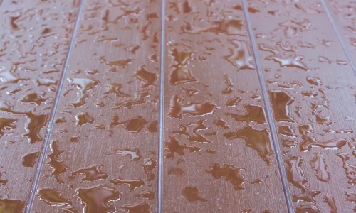 How do I ensure proper drainage and prevent water damage on my deck